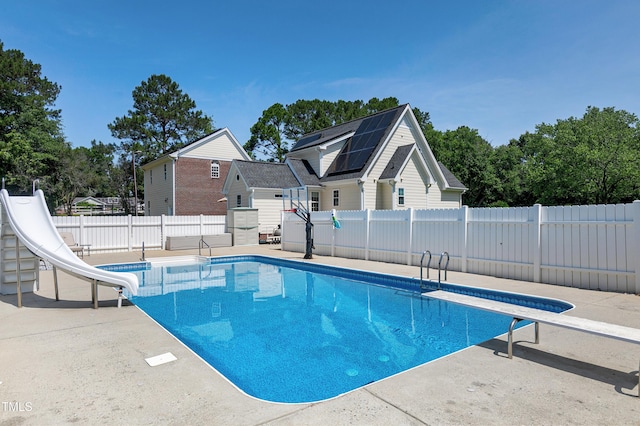 2709 Les Paul Ln, Apex, NC 27539 - view of pool with a water slide, a fenced backyard, a diving board, and a patio area