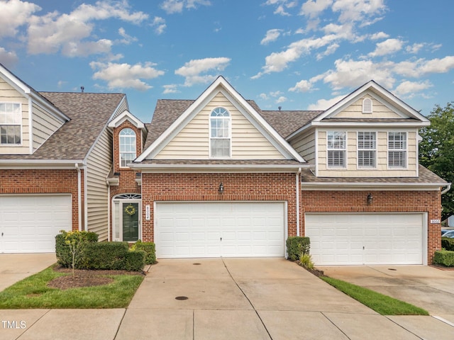 8004 Thrush Ridge Ln, Raleigh, NC 27615 - traditional home with brick siding, driveway, roof with shingles, and a garage