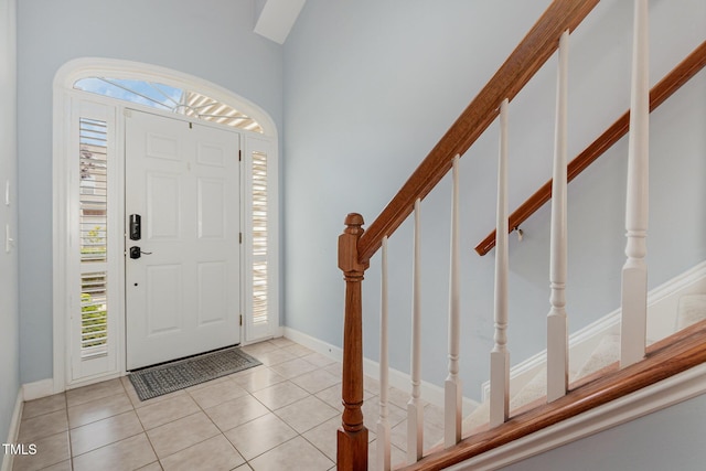 8004 Thrush Ridge Ln, Raleigh, NC 27615 - foyer entrance with stairway and light tile patterned flooring