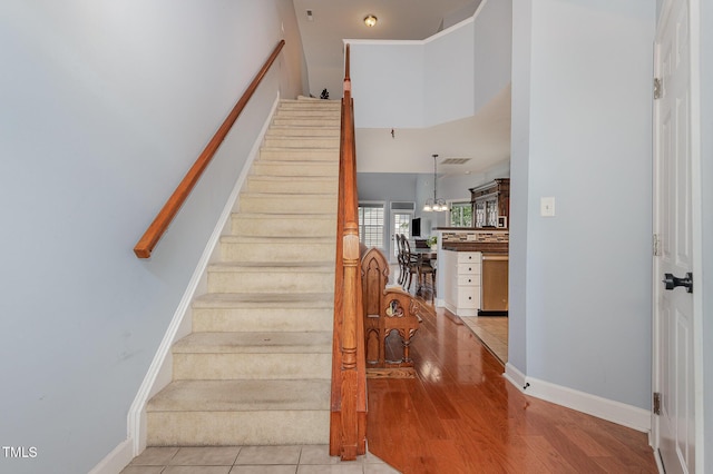 8004 Thrush Ridge Ln, Raleigh, NC 27615 - staircase with wood finished floors and a chandelier