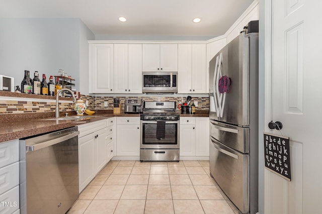 8004 Thrush Ridge Ln, Raleigh, NC 27615 - kitchen with appliances with stainless steel finishes, dark countertops, decorative backsplash, white cabinets, and recessed lighting