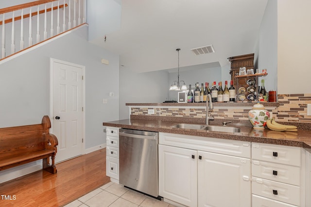 8004 Thrush Ridge Ln, Raleigh, NC 27615 - bar area featuring dishwasher, decorative backsplash, a chandelier, and pendant lighting