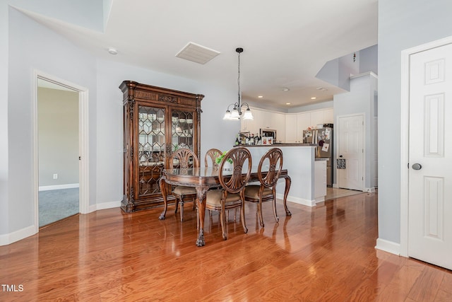 8004 Thrush Ridge Ln, Raleigh, NC 27615 - dining area with light wood-style flooring, a chandelier, and recessed lighting