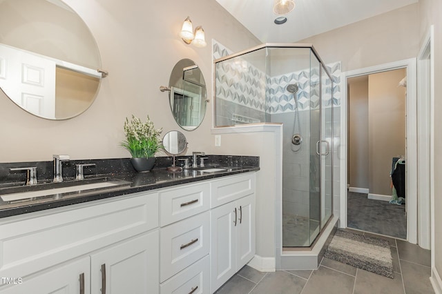 8004 Thrush Ridge Ln, Raleigh, NC 27615 - bathroom featuring double vanity, a shower stall, and tile patterned floors