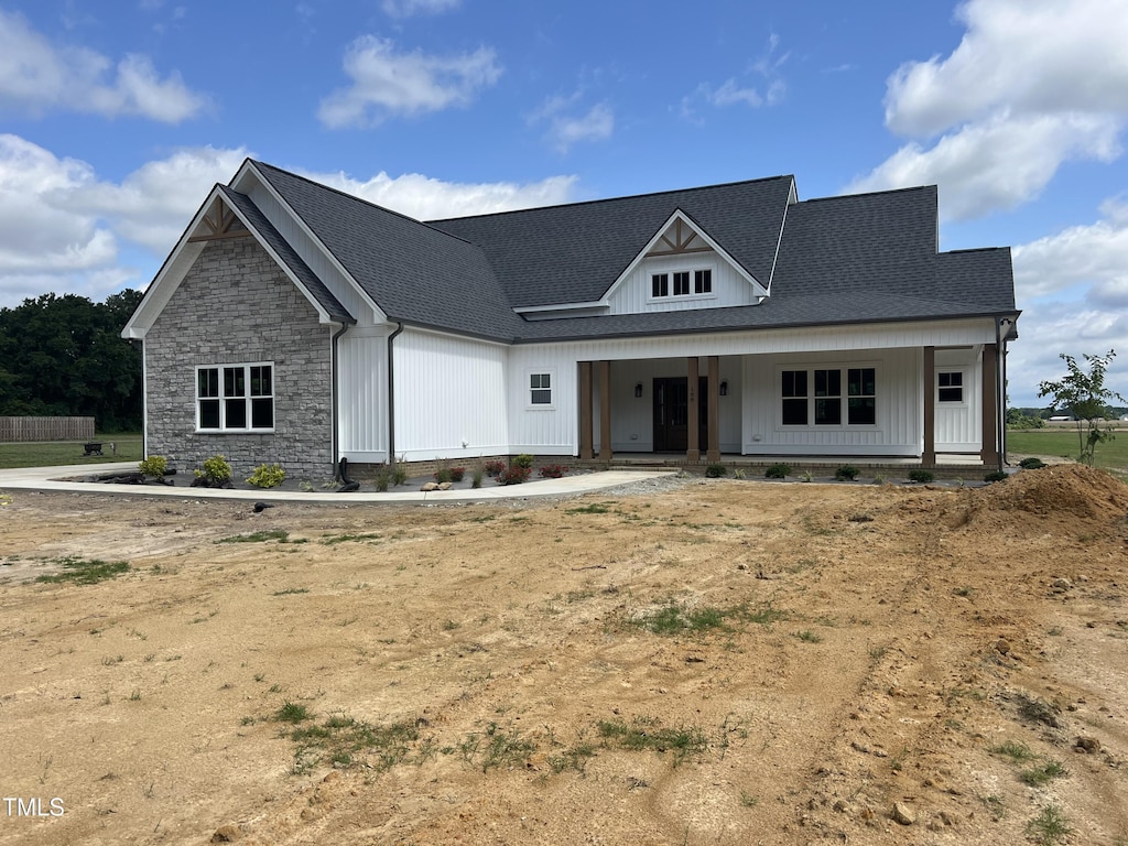 188 Banner Elk Rd, Benson, NC 27504 - modern farmhouse featuring stone siding, board and batten siding, roof with shingles, and a porch