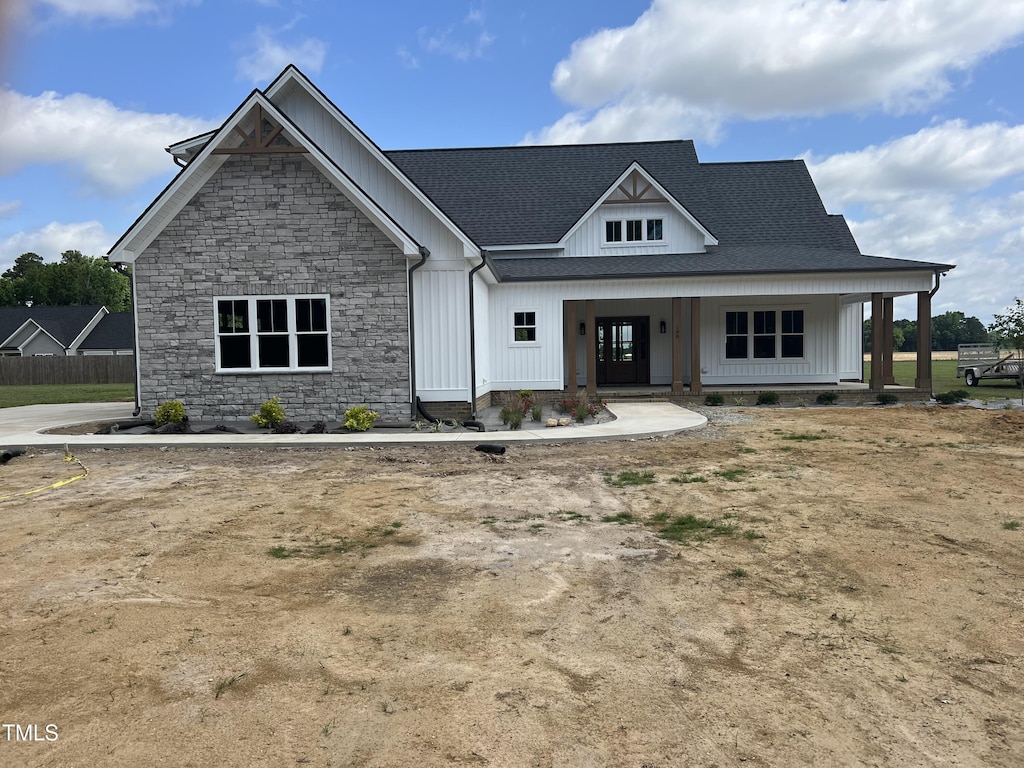 188 Banner Elk Rd, Benson, NC 27504 - modern inspired farmhouse featuring stone siding, a shingled roof, covered porch, and board and batten siding