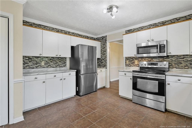 994 Eastman Rd, Fayetteville, NC 28314 - kitchen with appliances with stainless steel finishes, crown molding, light countertops, a textured ceiling, and tasteful backsplash