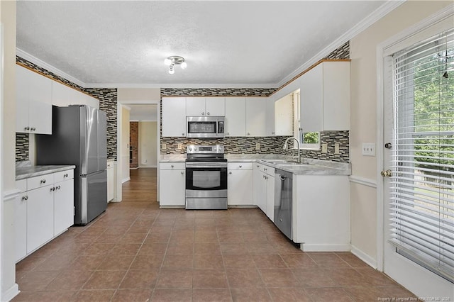 994 Eastman Rd, Fayetteville, NC 28314 - kitchen with stainless steel appliances, ornamental molding, tasteful backsplash, light countertops, and a sink