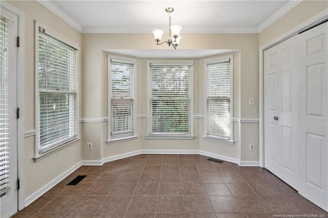 994 Eastman Rd, Fayetteville, NC 28314 - unfurnished dining area featuring a chandelier, ornamental molding, dark tile patterned floors, and baseboards