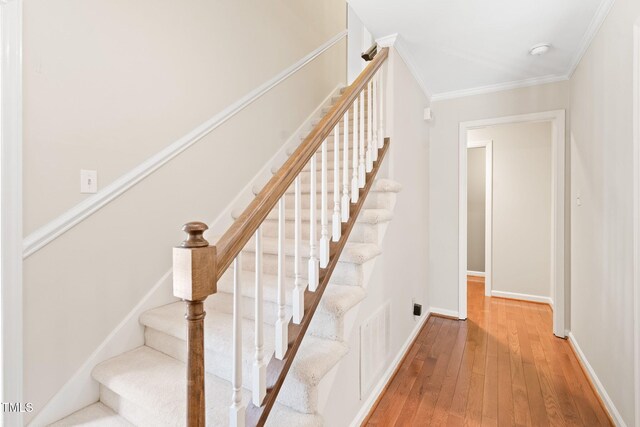 2107 Somers Ave, Burlington, NC 27215 - stairway featuring hardwood / wood-style flooring, ornamental molding, and baseboards