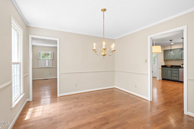 2107 Somers Ave, Burlington, NC 27215 - unfurnished room featuring a chandelier, light wood finished floors, baseboards, and ornamental molding