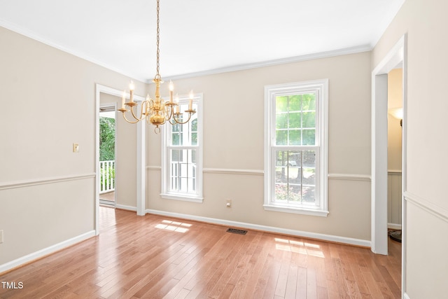 2107 Somers Ave, Burlington, NC 27215 - unfurnished dining area with a chandelier, hardwood / wood-style flooring, baseboards, and crown molding