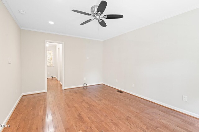 2107 Somers Ave, Burlington, NC 27215 - spare room featuring crown molding, light wood-style floors, a ceiling fan, baseboards, and a smoke detector