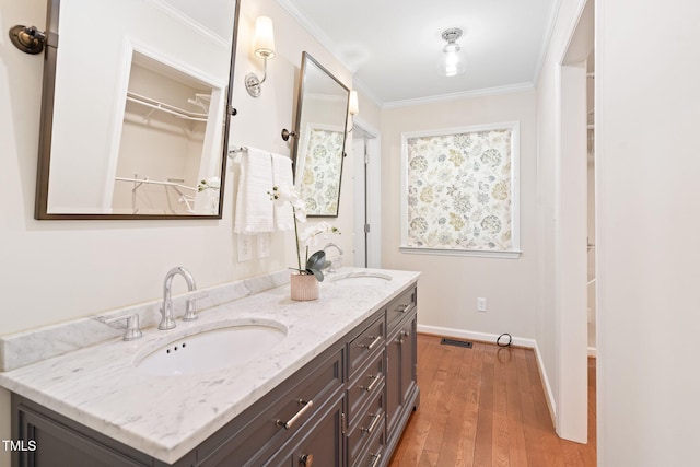 2107 Somers Ave, Burlington, NC 27215 - full bath with double vanity, crown molding, wood finished floors, baseboards, and a spacious closet