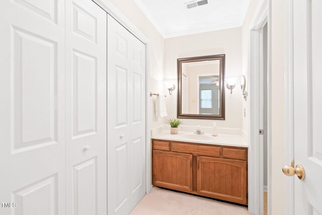 2107 Somers Ave, Burlington, NC 27215 - bathroom with vanity, ornamental molding, and a closet