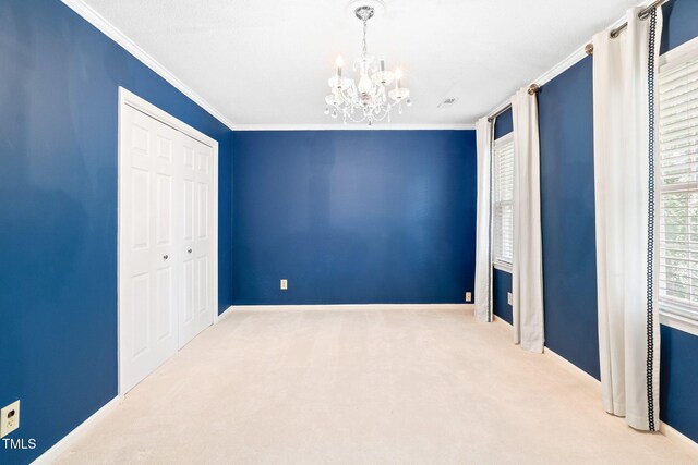 2107 Somers Ave, Burlington, NC 27215 - unfurnished bedroom with a chandelier, carpet flooring, crown molding, a closet, and baseboards