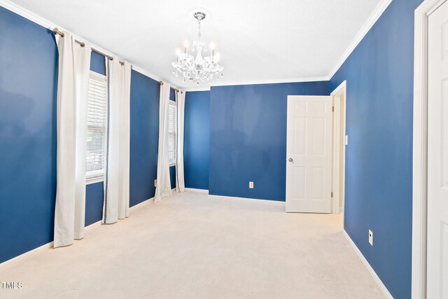 2107 Somers Ave, Burlington, NC 27215 - spare room featuring a chandelier, carpet flooring, ornamental molding, and baseboards