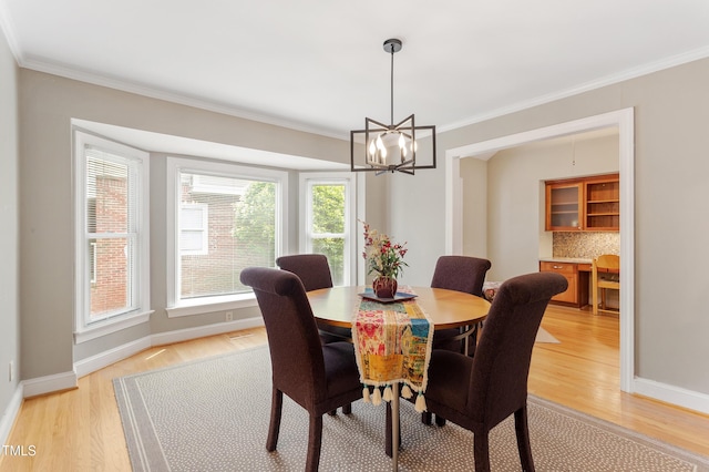 108 Ripplewater Ln, Cary, NC 27518 - dining space with light wood-type flooring, a chandelier, ornamental molding, and baseboards