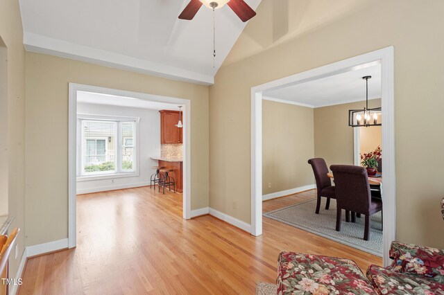 108 Ripplewater Ln, Cary, NC 27518 - dining room with light wood-type flooring, baseboards, ceiling fan, a chandelier, and vaulted ceiling