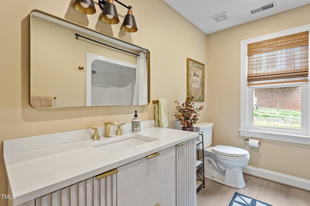 108 Ripplewater Ln, Cary, NC 27518 - bathroom with toilet, wood finished floors, vanity, baseboards, and a shower with curtain