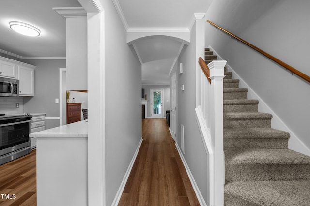 166 Greenmont Ln, Cary, NC 27511 - staircase featuring wood finished floors, arched walkways, crown molding, and baseboards
