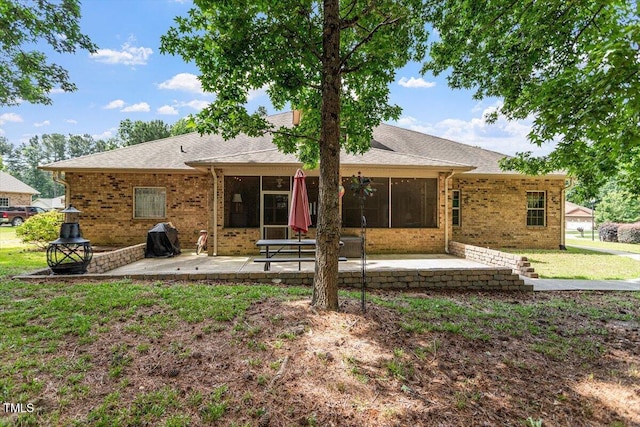 46 Spring Haven Ln, Willow Springs, NC 27592 - rear view of house with a patio, brick siding, a sunroom, a lawn, and roof with shingles