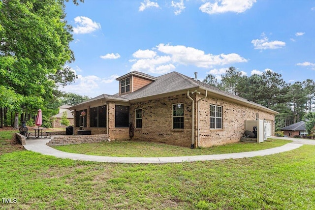 46 Spring Haven Ln, Willow Springs, NC 27592 - back of property featuring a garage, brick siding, a lawn, and roof with shingles