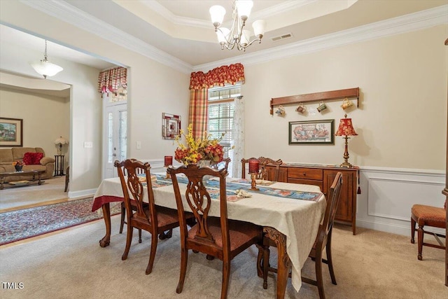 46 Spring Haven Ln, Willow Springs, NC 27592 - dining area featuring light colored carpet, a chandelier, crown molding, a raised ceiling, and a wainscoted wall