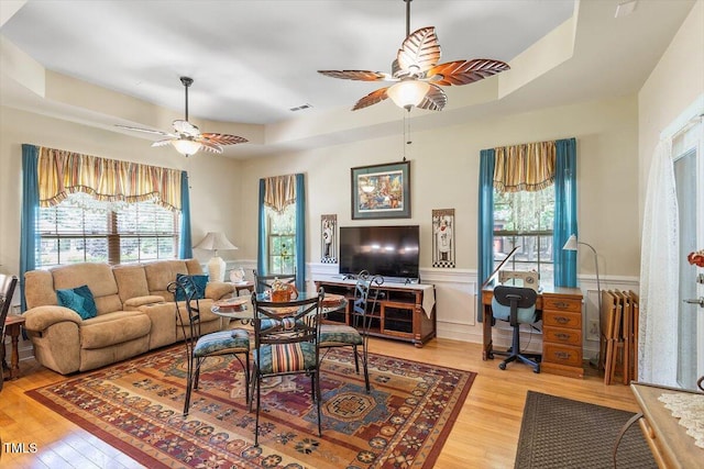 46 Spring Haven Ln, Willow Springs, NC 27592 - living room featuring a ceiling fan, light wood-type flooring, healthy amount of natural light, and a wainscoted wall