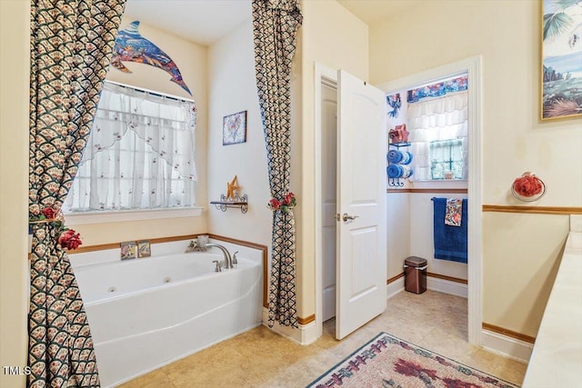 46 Spring Haven Ln, Willow Springs, NC 27592 - bathroom featuring a tub with jets, tile patterned floors, and baseboards