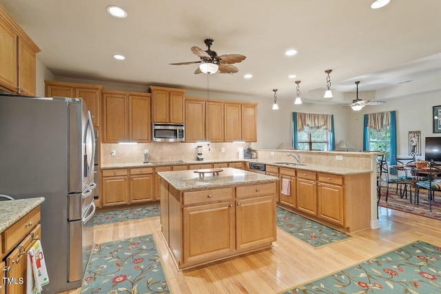 46 Spring Haven Ln, Willow Springs, NC 27592 - kitchen featuring stainless steel appliances, a ceiling fan, light wood finished floors, a peninsula, and recessed lighting