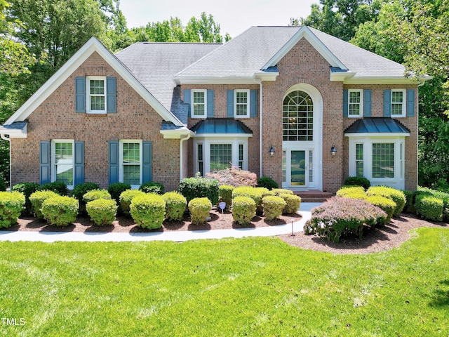 225 Midenhall Way, Cary, NC 27513 - view of front of home featuring brick siding and a front lawn