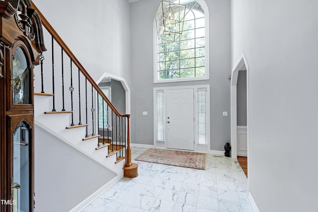 225 Midenhall Way, Cary, NC 27513 - entryway with a high ceiling, marble finish flooring, stairs, and baseboards