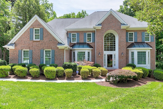225 Midenhall Way, Cary, NC 27513 - view of front of property featuring brick siding, a front yard, and a shingled roof