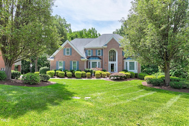 225 Midenhall Way, Cary, NC 27513 - colonial house featuring brick siding and a front yard