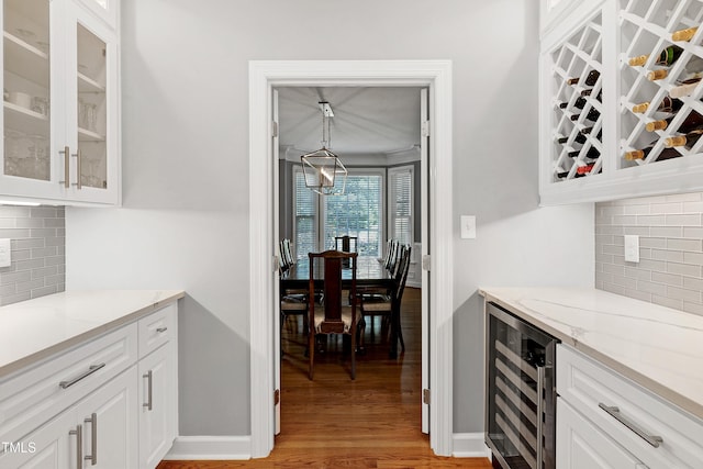 225 Midenhall Way, Cary, NC 27513 - indoor dry bar with beverage cooler, light wood-style flooring, and backsplash