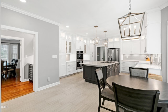 225 Midenhall Way, Cary, NC 27513 - kitchen featuring a chandelier, appliances with stainless steel finishes, backsplash, white cabinets, and recessed lighting