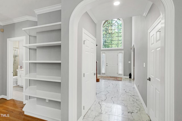 225 Midenhall Way, Cary, NC 27513 - entrance foyer featuring arched walkways, baseboards, marble finish flooring, and crown molding