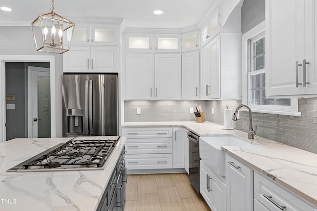 225 Midenhall Way, Cary, NC 27513 - kitchen featuring appliances with stainless steel finishes, a sink, white cabinets, a chandelier, and recessed lighting