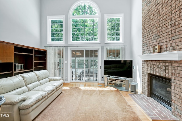225 Midenhall Way, Cary, NC 27513 - living room with a high ceiling, a fireplace, and wood finished floors