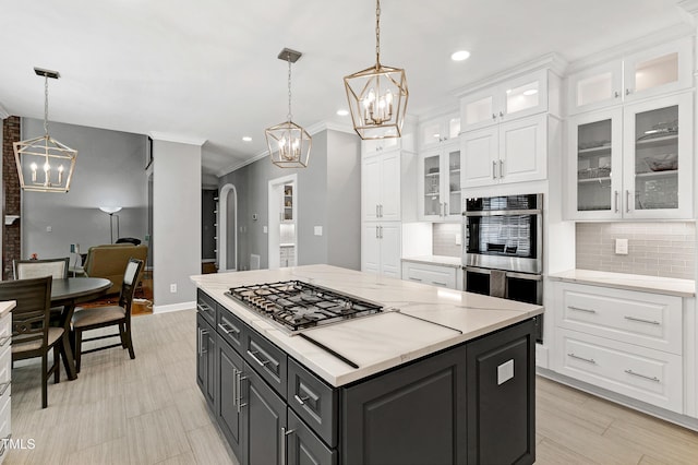 225 Midenhall Way, Cary, NC 27513 - kitchen featuring a chandelier, stainless steel appliances, white cabinetry, ornamental molding, and tasteful backsplash