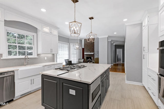 225 Midenhall Way, Cary, NC 27513 - kitchen with appliances with stainless steel finishes, a sink, white cabinets, a chandelier, and recessed lighting