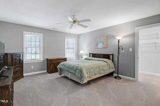 225 Midenhall Way, Cary, NC 27513 - carpeted bedroom with baseboards, a ceiling fan, and a walk in closet