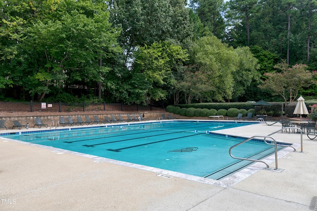 225 Midenhall Way, Cary, NC 27513 - community pool featuring a patio area and view of wooded area