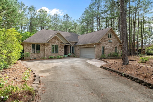 174 Woodwedge Way, Sanford, NC 27332 - view of front of home with brick siding, driveway, a garage, and roof with shingles
