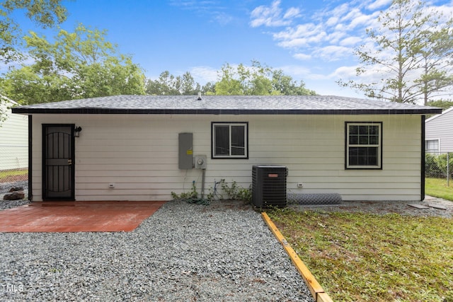 1204 Pecan Pl, Durham, NC 27704 - back of house with cooling unit, a patio, and roof with shingles