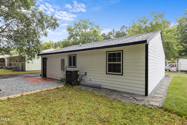 1204 Pecan Pl, Durham, NC 27704 - rear view of property with central air condition unit, roof with shingles, and a patio
