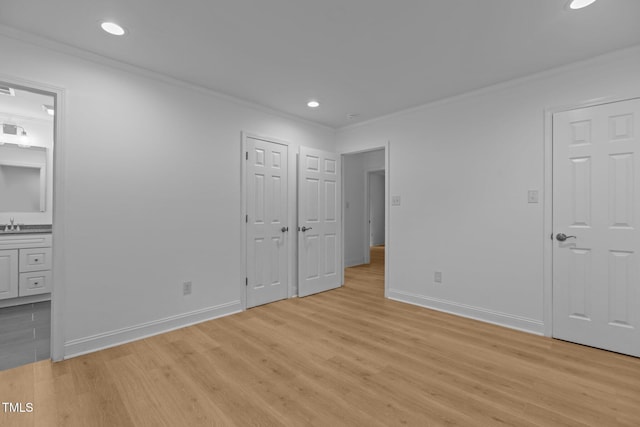 1204 Pecan Pl, Durham, NC 27704 - unfurnished bedroom with crown molding, light wood finished floors, baseboards, ensuite bath, and recessed lighting