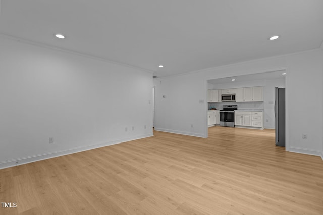 1204 Pecan Pl, Durham, NC 27704 - unfurnished living room featuring recessed lighting, ornamental molding, light wood-style floors, and baseboards