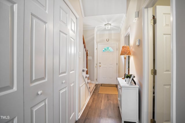 114 Colchis Ct, Cary, NC 27513 - doorway to outside with dark wood-style flooring, crown molding, baseboards, and stairway